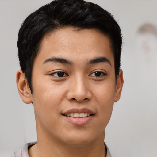 Joyful asian young-adult male with short  brown hair and brown eyes