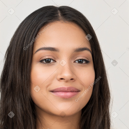 Joyful latino young-adult female with long  brown hair and brown eyes