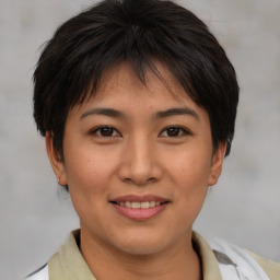 Joyful asian young-adult female with short  brown hair and brown eyes