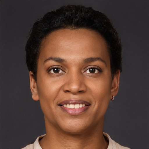 Joyful black young-adult female with short  black hair and brown eyes