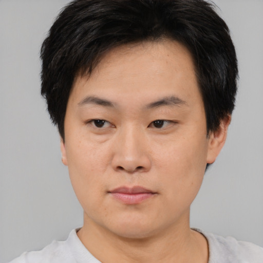 Neutral asian young-adult male with short  brown hair and brown eyes