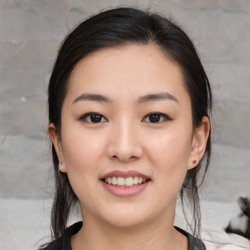 Joyful white young-adult female with medium  black hair and brown eyes