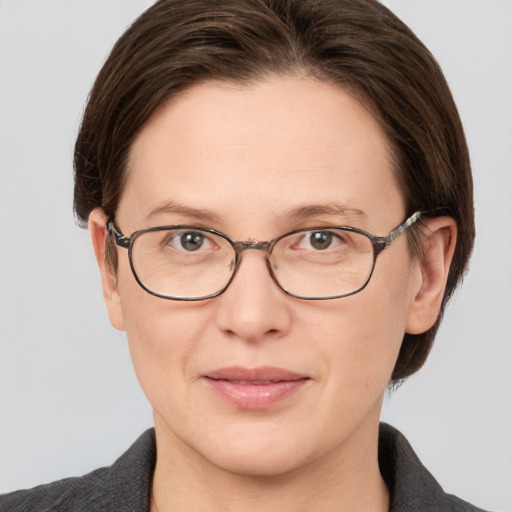 Joyful white adult female with medium  brown hair and grey eyes