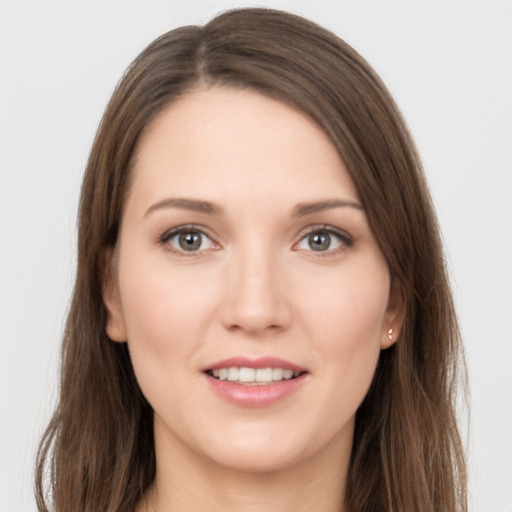 Joyful white young-adult female with long  brown hair and grey eyes