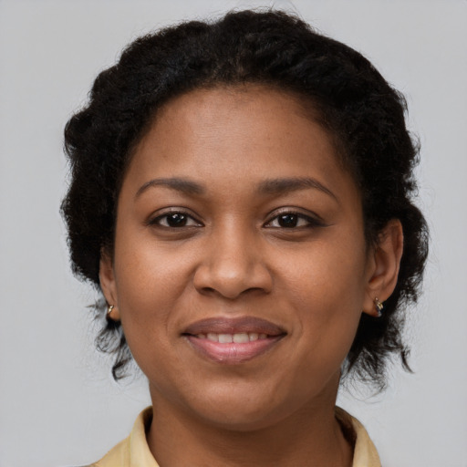 Joyful black young-adult female with medium  brown hair and brown eyes
