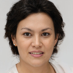 Joyful white adult female with medium  brown hair and brown eyes