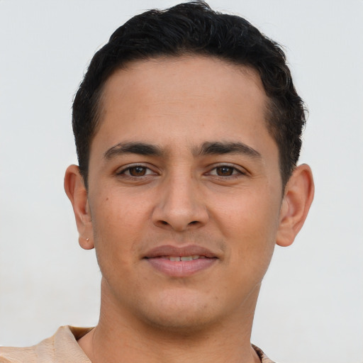 Joyful latino young-adult male with short  brown hair and brown eyes