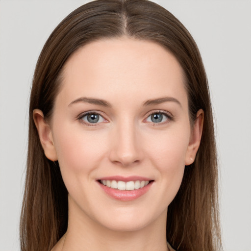 Joyful white young-adult female with long  brown hair and grey eyes