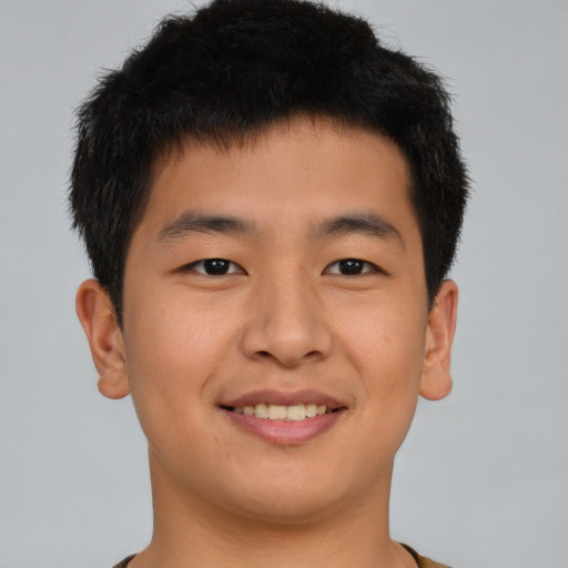 Joyful asian young-adult male with short  brown hair and brown eyes