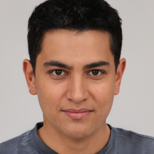 Joyful latino young-adult male with short  black hair and brown eyes