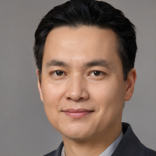 Joyful white adult male with short  black hair and brown eyes