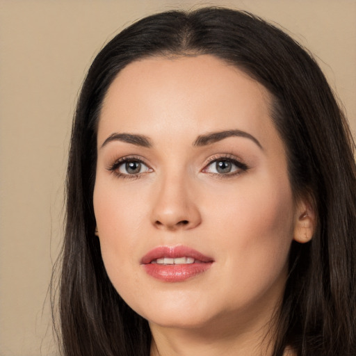 Joyful white young-adult female with long  black hair and brown eyes