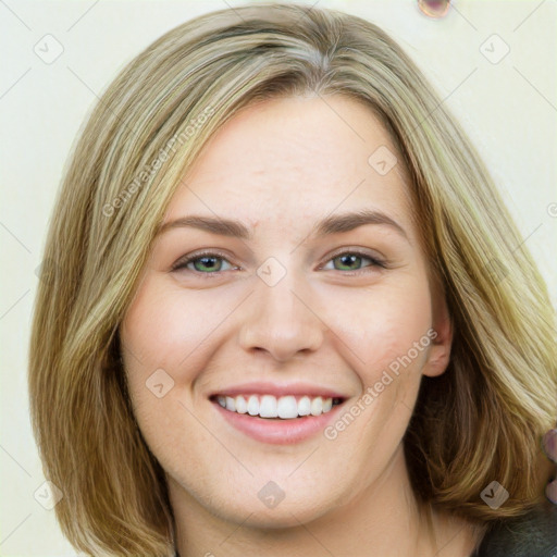 Joyful white young-adult female with medium  brown hair and green eyes