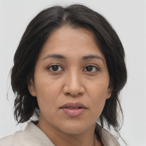 Joyful asian adult female with medium  brown hair and brown eyes