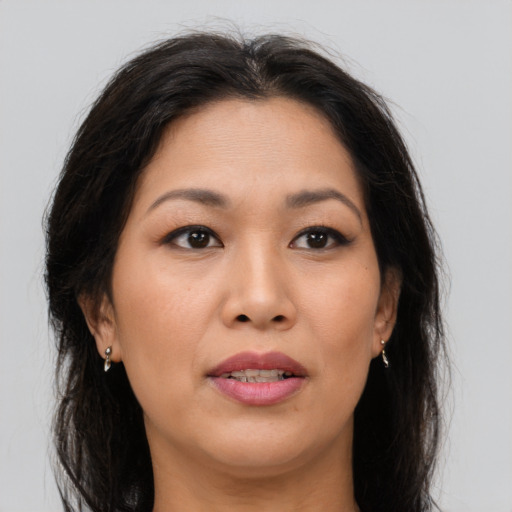 Joyful asian young-adult female with long  brown hair and brown eyes