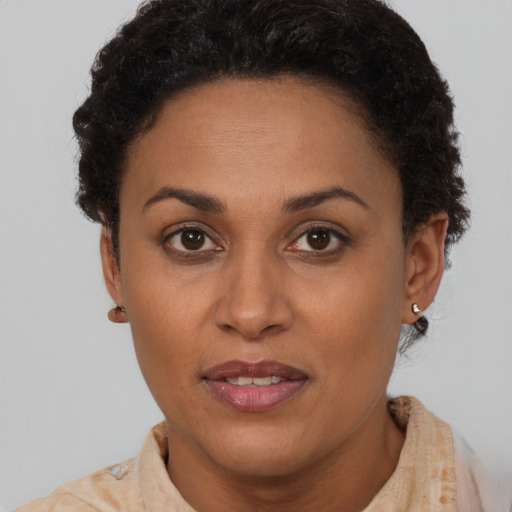 Joyful latino adult female with short  brown hair and brown eyes