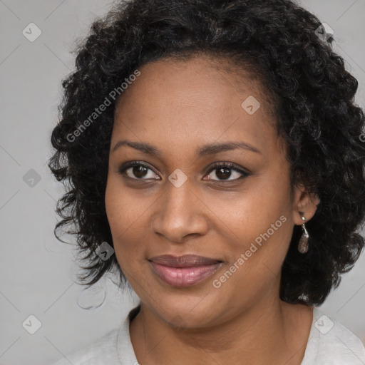 Joyful black young-adult female with long  brown hair and brown eyes