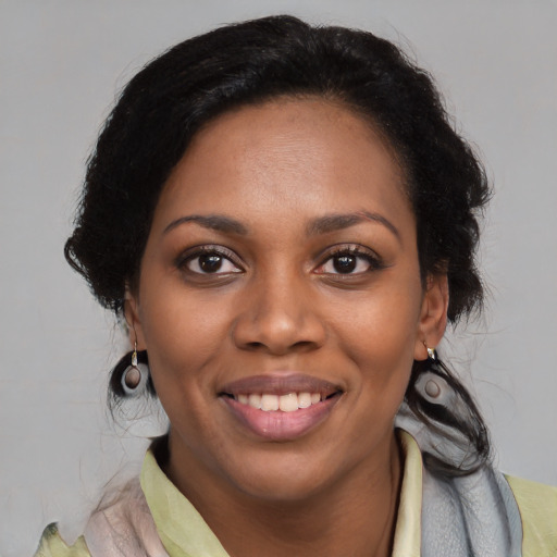 Joyful latino young-adult female with medium  brown hair and brown eyes