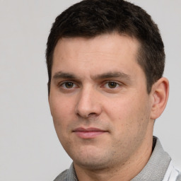 Joyful white young-adult male with short  black hair and brown eyes