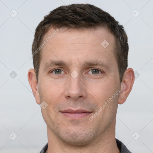 Joyful white adult male with short  brown hair and grey eyes