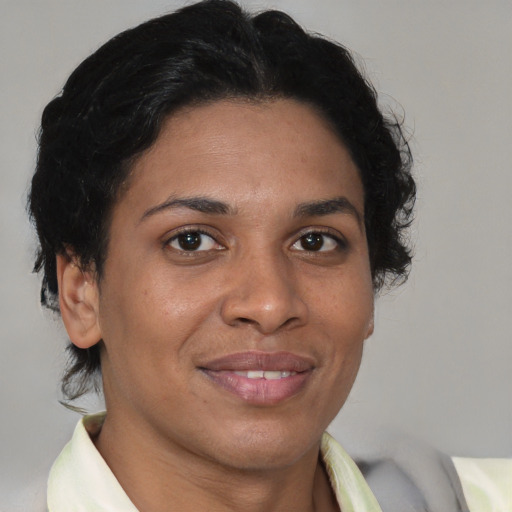 Joyful latino adult female with short  brown hair and brown eyes