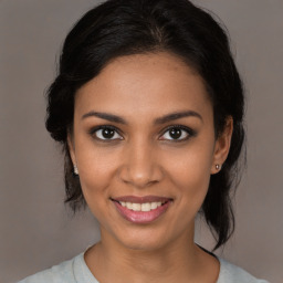 Joyful black young-adult female with medium  brown hair and brown eyes