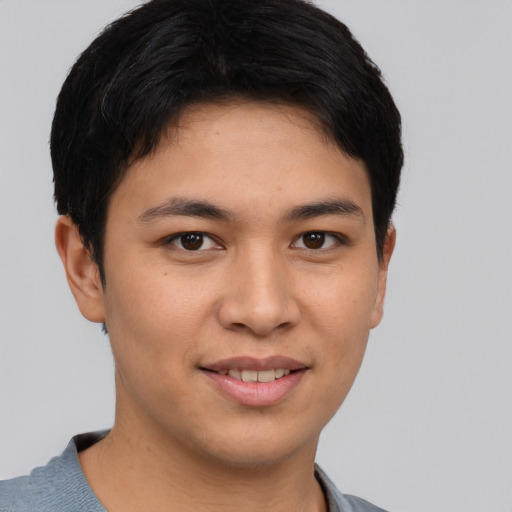 Joyful asian young-adult male with short  brown hair and brown eyes