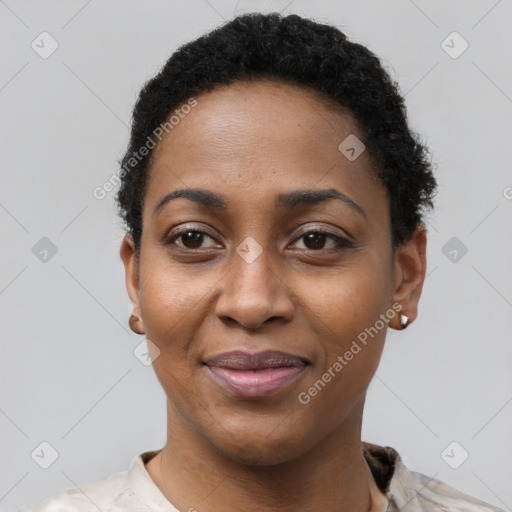 Joyful black young-adult female with short  black hair and brown eyes