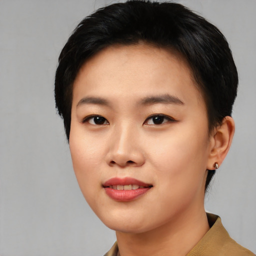Joyful asian young-adult female with short  black hair and brown eyes