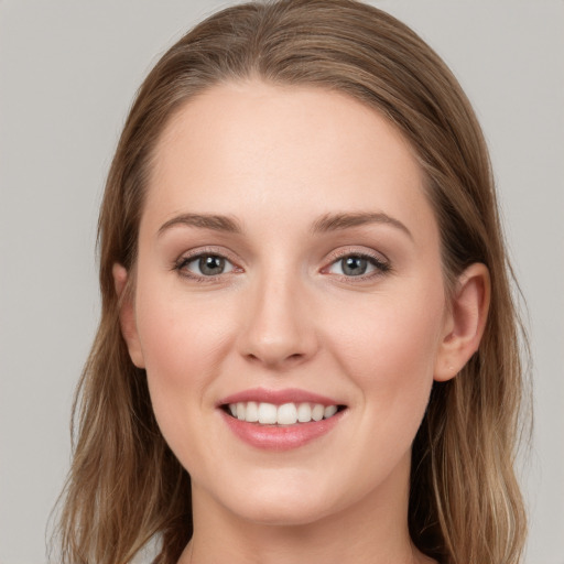 Joyful white young-adult female with long  brown hair and blue eyes