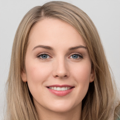 Joyful white young-adult female with long  brown hair and grey eyes