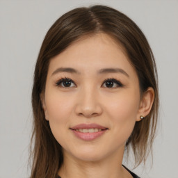 Joyful asian young-adult female with long  brown hair and brown eyes