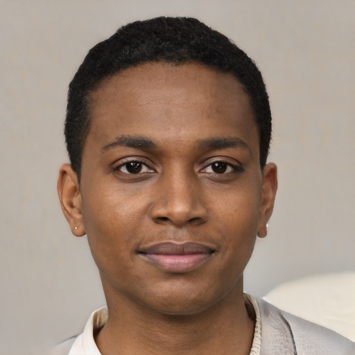 Joyful black young-adult male with short  black hair and brown eyes