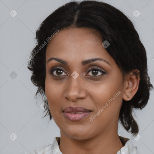 Joyful black young-adult female with medium  brown hair and brown eyes