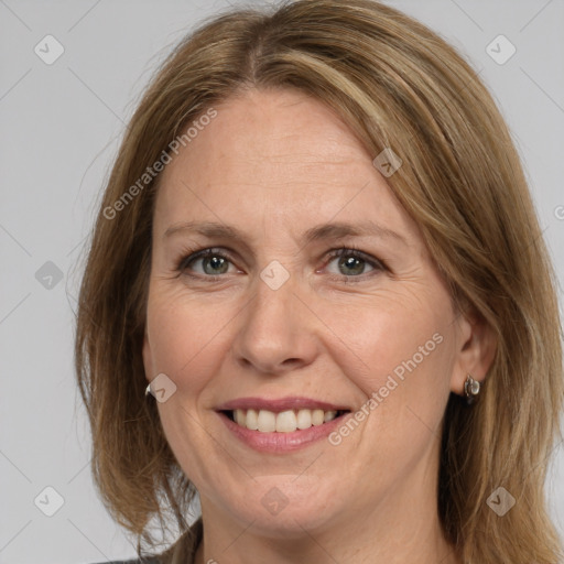 Joyful white adult female with medium  brown hair and grey eyes