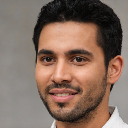 Joyful white young-adult male with short  black hair and brown eyes