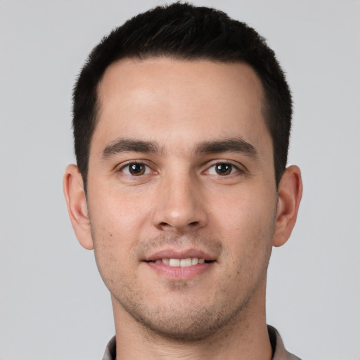 Joyful white young-adult male with short  brown hair and brown eyes