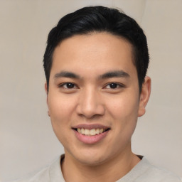 Joyful asian young-adult male with short  black hair and brown eyes