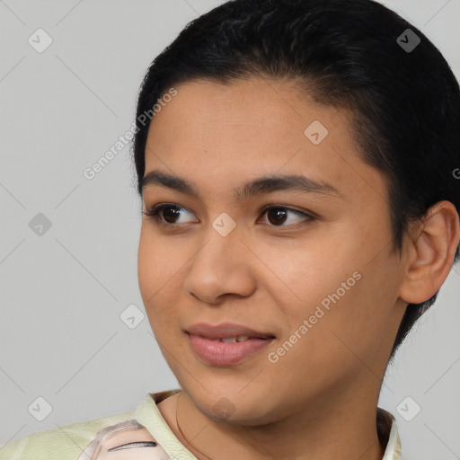 Joyful latino young-adult female with short  black hair and brown eyes