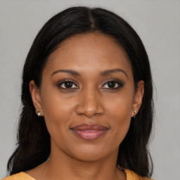 Joyful black adult female with medium  brown hair and brown eyes