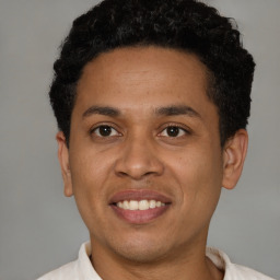 Joyful latino young-adult male with short  brown hair and brown eyes