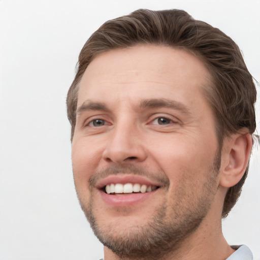 Joyful white young-adult male with short  brown hair and grey eyes