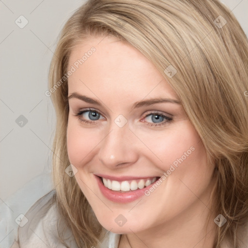 Joyful white young-adult female with medium  brown hair and blue eyes