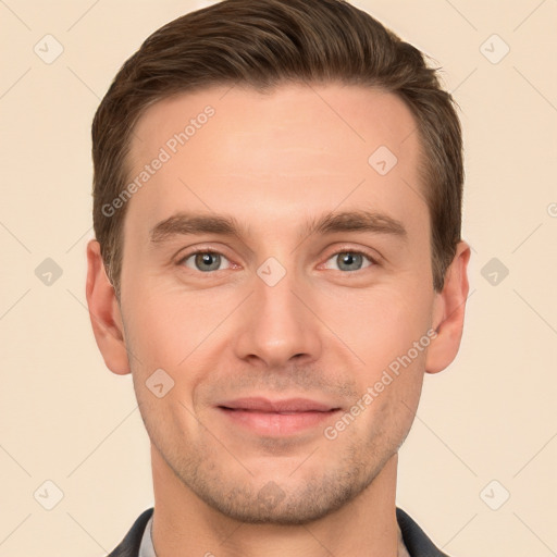 Joyful white young-adult male with short  brown hair and grey eyes