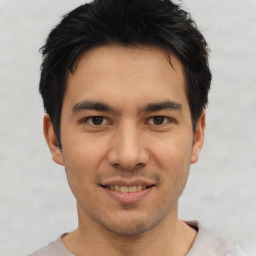 Joyful asian young-adult male with short  black hair and brown eyes