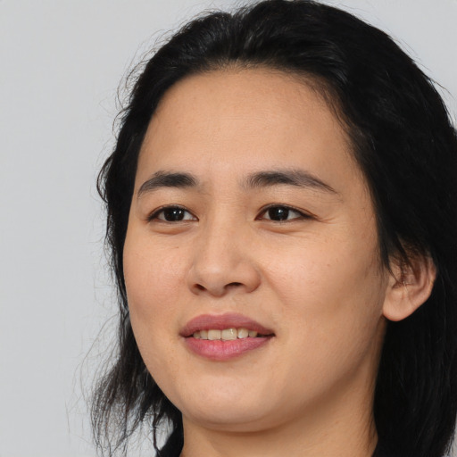 Joyful asian young-adult female with medium  black hair and brown eyes