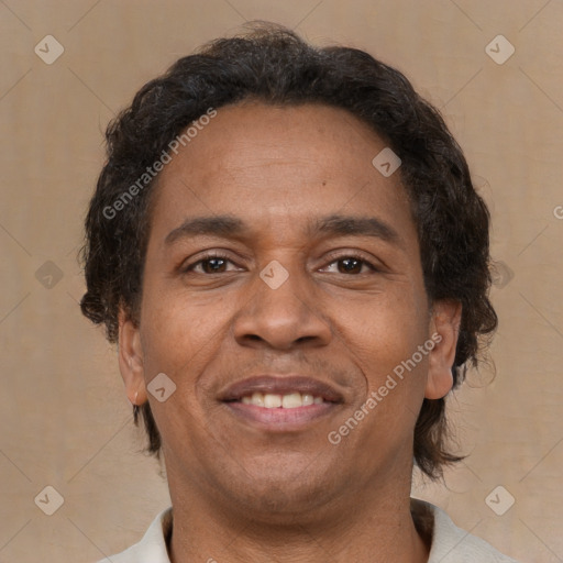 Joyful latino adult male with short  brown hair and brown eyes