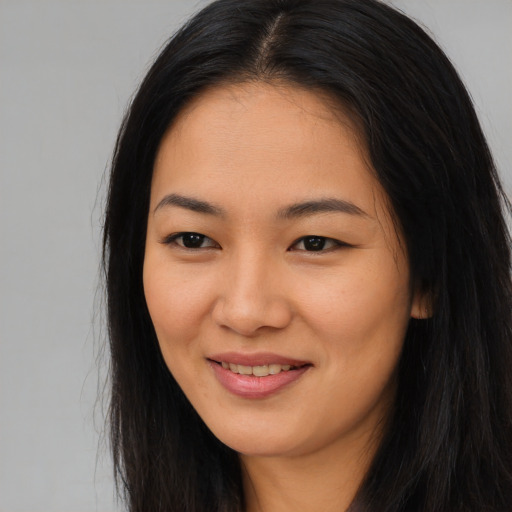 Joyful asian young-adult female with long  black hair and brown eyes