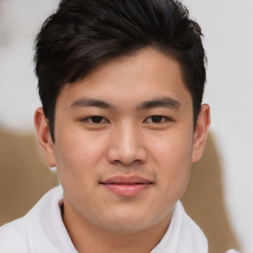 Joyful asian young-adult male with short  brown hair and brown eyes