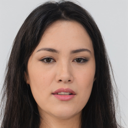 Joyful asian young-adult female with long  brown hair and brown eyes